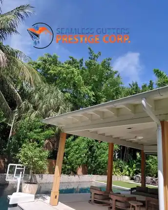 A poolside covered patio with a new white gutter along the roof edge, carrying rain away from the deck